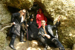 Solemnity-bändin jäsenet poseeraavat keskellä pöpelikköä sijaitsevassa luolamaisessa syvennyksessä pukeutuneina naamiaisasuihin. Yksi mies näyttää vampyyrilta, toinen punaiseen kaapuun pukeutuneelta kirkonmieheltä ja yksi nahkavetimiin sonnustautunut hepp