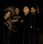 Neljä mustiin pukeutunutta deathcore-yhtyeen jäsentä seisoo mustaa taustaa vasten valokuvassa, jossa värit ovat pääsääntöisesti tummanruskeaa ja mustaa.