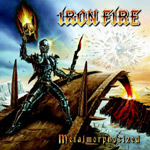 Iron Firen logo kuvan oikeassa yläkulmassa ja alakulmassa lukee "Metalmorphosized". Kuvaa hallitsee piirretty maisema sillasta, jonka toisella laidalla seisoo rautainen ihmishahmo, jolla suuri tulipallo kädessä.