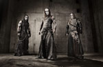 Ryhmäkuva kolmesta Behemothin jäsenestä, joista keskimmäisenä on Nergal. Jäsenet ovat pitkähiuksisia miehiä, jotka pukeutuneet mustiin nahkavaatteisiin.