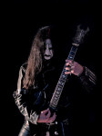 Chaq Mol seisoo kitara kourissaan mustaa taustaa vasten. Miehellä yllään musta nahkatakki ja -housut, päässä pitkät hiukset ja kasvoilla jyrmyn katseen kera corpse-maskit.